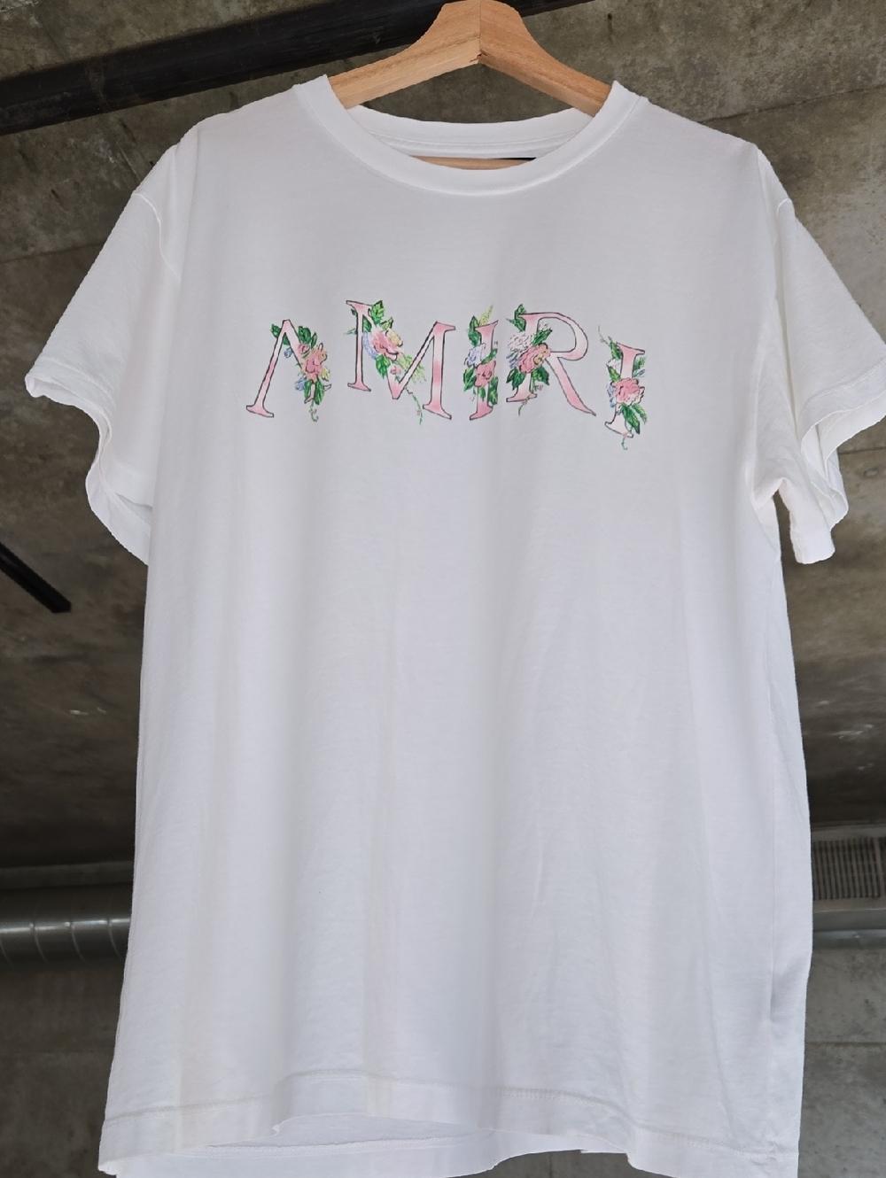 AMIRI White Tee with Pink Floral Logo and Green Accents